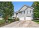 Traditional home showcasing a two-car garage and wood staircase at 40 Browning Dr, Covington, GA 30016