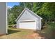 Garage with a large door, set against a backdrop of mature trees at 40 Browning Dr, Covington, GA 30016