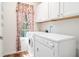 Bright laundry room featuring a window with floral print curtains at 40 Browning Dr, Covington, GA 30016