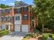 Charming brick townhome featuring a two-car garage and landscaped front yard at 406 Heritage Park Nw Trce # 22, Kennesaw, GA 30144