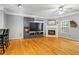 Bright living room boasts a fireplace, hardwood floors, and neutral wall color at 406 Heritage Park Nw Trce # 22, Kennesaw, GA 30144
