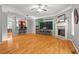 Open-concept living room with hardwood floors, fireplace, and bar seating area at 406 Heritage Park Nw Trce # 22, Kennesaw, GA 30144