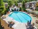 Community pool with lounge chairs and landscaped surroundings at 406 Heritage Park Nw Trce # 22, Kennesaw, GA 30144