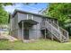 Back exterior view of a gray home featuring a stairwell, porch, and fenced yard at 1328 Eason Nw St, Atlanta, GA 30314