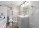 Bathroom with tub, toilet, and sink, featuring a modern vanity and lighting for a stylish and functional space at 1328 Eason Nw St, Atlanta, GA 30314
