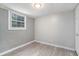 Simple yet cozy room with wood floors, a window, a door, and fresh paint, making it a perfect sanctuary at 1328 Eason Nw St, Atlanta, GA 30314