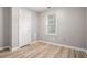 Comfortable bedroom with wood flooring, a window, and a closet, providing a simple and functional space at 1328 Eason Nw St, Atlanta, GA 30314