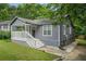 Charming home with gray siding, a covered front porch with white railing, and green lawn at 1328 Eason Nw St, Atlanta, GA 30314