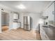 Stylish kitchen featuring stainless steel appliances, granite countertops, and wood flooring, creating a contemporary look at 1328 Eason Nw St, Atlanta, GA 30314