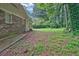 Backyard with lush green grass, foliage, and the rear of the property at 1724 Rhonda Ln, Stone Mountain, GA 30087
