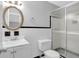 Classic bathroom with white tile, framed mirror, and glass-enclosed shower at 1724 Rhonda Ln, Stone Mountain, GA 30087