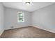 Comfortable bedroom featuring plush carpeting and natural light from a window at 1724 Rhonda Ln, Stone Mountain, GA 30087