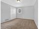 Bright bedroom with neutral walls and carpeted floors at 1724 Rhonda Ln, Stone Mountain, GA 30087