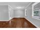 Serene bedroom featuring hardwood floors, fresh paint, large windows, and ample natural light at 1724 Rhonda Ln, Stone Mountain, GA 30087
