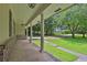 Inviting covered front porch with brick detailing, supporting columns, and a view of the landscaped yard at 1724 Rhonda Ln, Stone Mountain, GA 30087