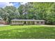 Charming single-story home with well-maintained lawn and mature trees at 1724 Rhonda Ln, Stone Mountain, GA 30087