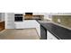 Bright kitchen featuring white cabinets, tile backsplash, and black countertops at 1724 Rhonda Ln, Stone Mountain, GA 30087