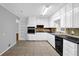 Well-lit kitchen with white cabinetry, tile backsplash, and black appliances at 1724 Rhonda Ln, Stone Mountain, GA 30087