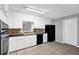 Spacious kitchen featuring white cabinets and black appliances at 1724 Rhonda Ln, Stone Mountain, GA 30087