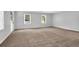 Spacious living room with carpet, great natural light and neutral walls at 1724 Rhonda Ln, Stone Mountain, GA 30087
