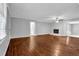 Open living room with hardwood floors, a decorative white brick fireplace, and an open concept design at 1724 Rhonda Ln, Stone Mountain, GA 30087