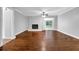 Spacious living room featuring hardwood floors, a decorative fireplace, and sliding glass doors at 1724 Rhonda Ln, Stone Mountain, GA 30087