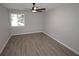 This bedroom has a ceiling fan, window, and gray vinyl floors at 346 Carpenter Drive Northeast Dr # 32, Sandy Springs, GA 30328