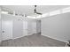 Spacious bedroom with sleek, gray floors, white walls, and modern ceiling fan at 346 Carpenter Drive Northeast Dr # 32, Sandy Springs, GA 30328
