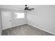 This bedroom has a ceiling fan, window, and gray vinyl floors at 346 Carpenter Drive Northeast Dr # 32, Sandy Springs, GA 30328