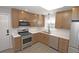 Modern kitchen featuring stainless steel appliances, a gas range, and wooden cabinets at 346 Carpenter Drive Northeast Dr # 32, Sandy Springs, GA 30328