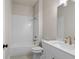 Cozy bathroom featuring a tub with white tiled walls, a white vanity, and warm bronze hardware at 513 Godfrey Dr, Cumming, GA 30040