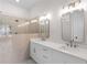 Bright bathroom with a walk-in shower featuring a glass enclosure and double vanity sinks at 513 Godfrey Dr, Cumming, GA 30040