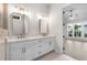 Bright bathroom with a walk-in shower and double vanity sinks overlooking the living area at 513 Godfrey Dr, Cumming, GA 30040