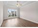 Bedroom with tray ceiling, ceiling fan, large windows that bring in natural light, and hardwood floors at 513 Godfrey Dr, Cumming, GA 30040