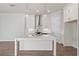 Stylish kitchen with a large island, white cabinetry, and stainless steel appliances at 513 Godfrey Dr, Cumming, GA 30040