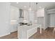 Beautiful kitchen with white cabinets, quartz countertops, and designer lighting at 513 Godfrey Dr, Cumming, GA 30040