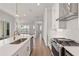 Open kitchen with white cabinets, an island with a sink, and stainless steel appliances at 513 Godfrey Dr, Cumming, GA 30040