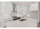 Bright kitchen with stainless steel range, white cabinetry, quartz countertops and modern fixtures at 513 Godfrey Dr, Cumming, GA 30040
