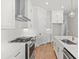 Modern kitchen featuring white cabinets, stainless steel appliances, an island, and gold hardware accents at 513 Godfrey Dr, Cumming, GA 30040