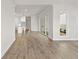 Bright, open living area with wood floors and access to a modern kitchen through sliding doors at 513 Godfrey Dr, Cumming, GA 30040