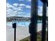 Upscale community pool with lounge chairs, blue skies, and crisp clean water surrounded by a metal fence for added security at 513 Godfrey Dr, Cumming, GA 30040