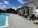 Resort-style pool area with comfortable seating and lush landscaping in a well-maintained community at 513 Godfrey Dr, Cumming, GA 30040