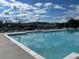 Large community pool surrounded by lounge chairs, perfect for relaxing on a sunny day at 513 Godfrey Dr, Cumming, GA 30040