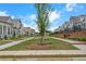Picturesque street view showcasing charming homes with sidewalks, greenery, and manicured lawns at 513 Godfrey Dr, Cumming, GA 30040