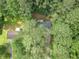 Aerial view of house nestled among mature, dense trees and lush greenery, showing roof and driveway at 2806 Hedgewood Nw Dr, Atlanta, GA 30311