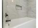 Close up on a modern bathtub with tile wall and black hardware at 2806 Hedgewood Nw Dr, Atlanta, GA 30311