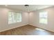 Light-filled bedroom with wood-look floors and windows providing a view of the outdoors at 2806 Hedgewood Nw Dr, Atlanta, GA 30311