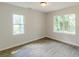 Bedroom with wood-look floors and two windows offering natural light at 2806 Hedgewood Nw Dr, Atlanta, GA 30311