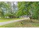 Charming single-story home with a long driveway surrounded by mature trees and a lush lawn at 2806 Hedgewood Nw Dr, Atlanta, GA 30311