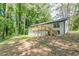 Charming home featuring a wooden deck overlooking a spacious backyard with lush greenery at 2806 Hedgewood Nw Dr, Atlanta, GA 30311